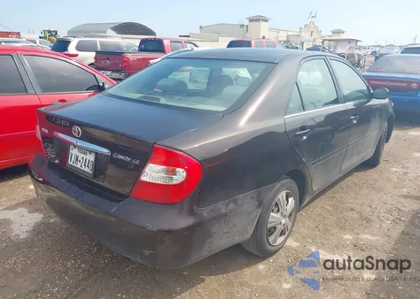 2002 Toyota Camry Le z USA, uszkodzony, nr VIN JTDBE32K720119418